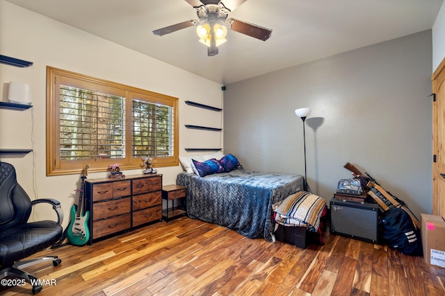 bedroom featuring a ceiling fan and wood finished floors