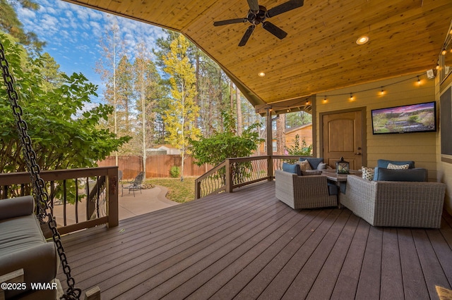 deck with an outdoor living space, a ceiling fan, and fence