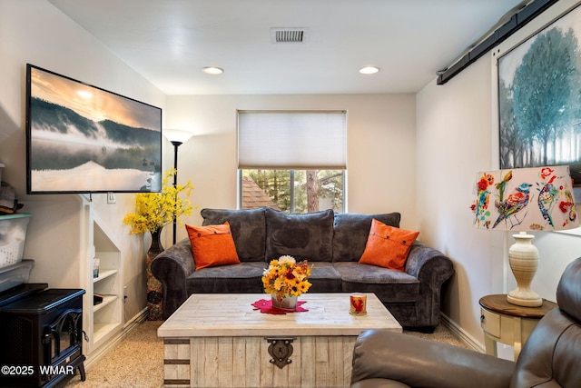 living room featuring recessed lighting, baseboards, and visible vents