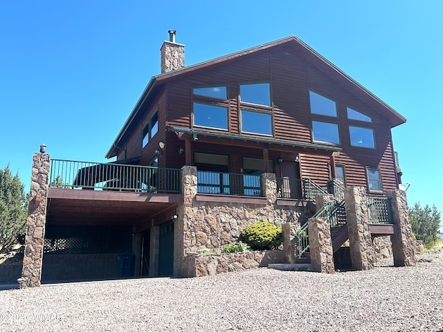 822 E 1st Ln, Eagar, AZ 85925 - view of front facade featuring stone siding, a chimney, and stairs