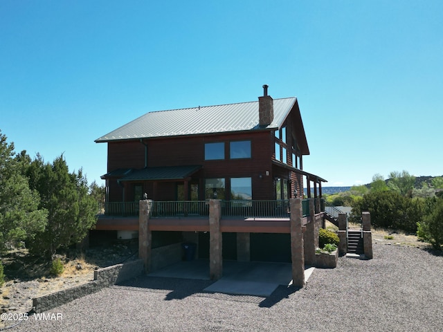 822 E 1st Ln, Eagar, AZ 85925 - back of property featuring a chimney, metal roof, and a wooden deck