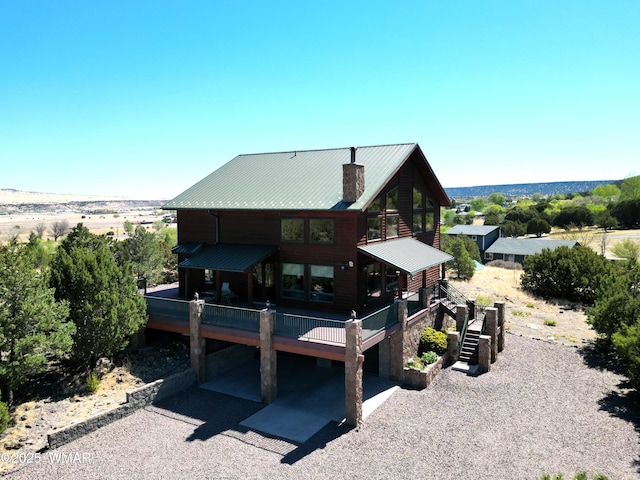 822 E 1st Ln, Eagar, AZ 85925 - rear view of property featuring stairs, a chimney, metal roof, and a deck