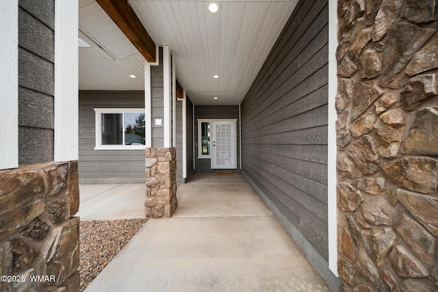 property entrance with stone siding