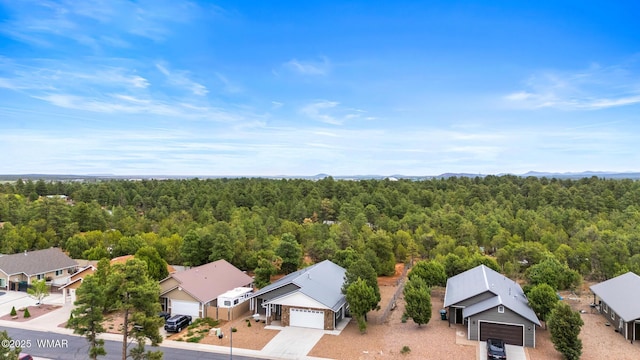 aerial perspective of suburban area featuring a forest