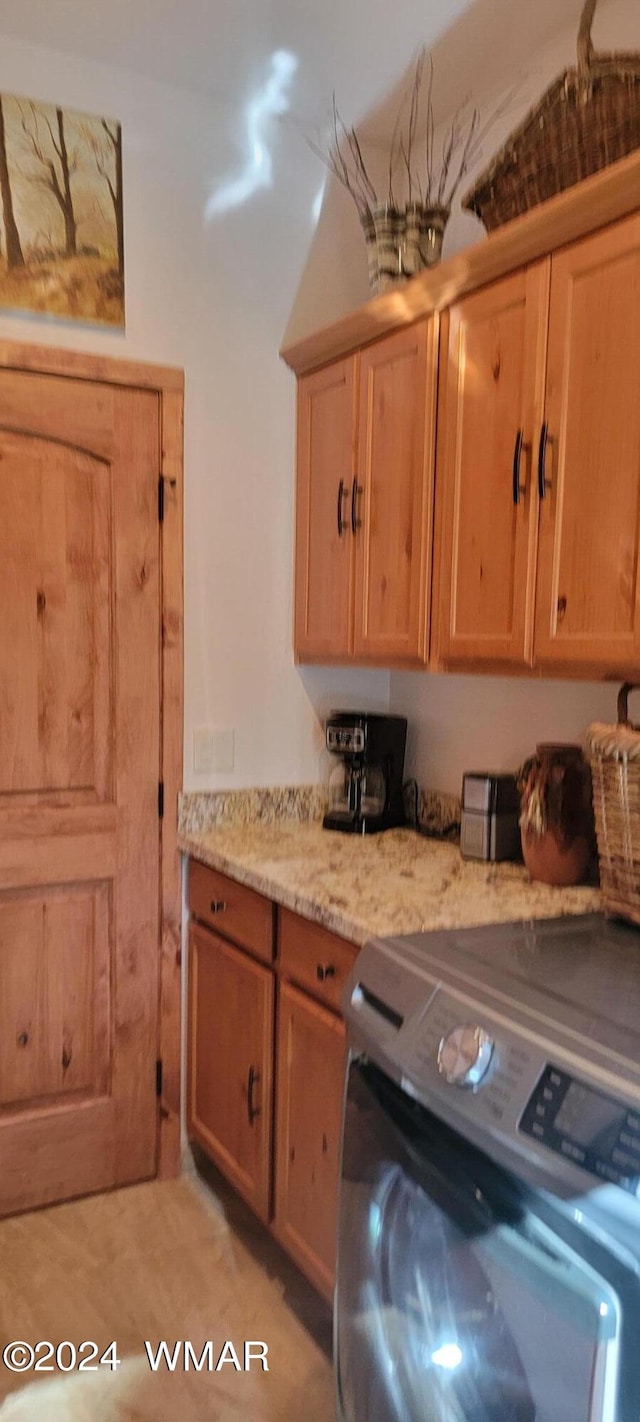 laundry room featuring washer / clothes dryer and cabinet space