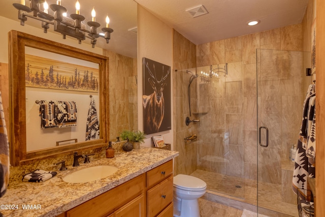 full bathroom with a stall shower, vanity, and toilet