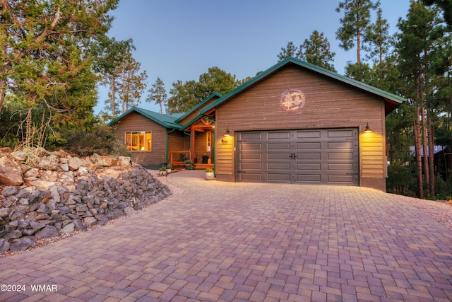 view of front of home featuring a garage and decorative driveway