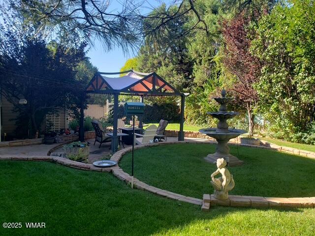 view of community featuring a patio area and a yard