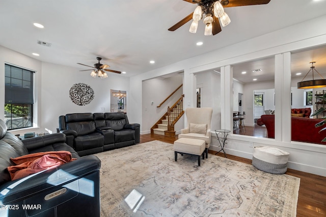 living room featuring recessed lighting, visible vents, stairway, and wood finished floors