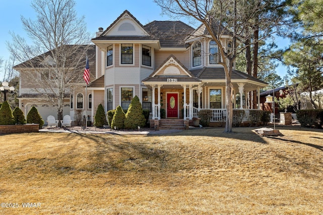 victorian home featuring a porch, a chimney, and a front lawn