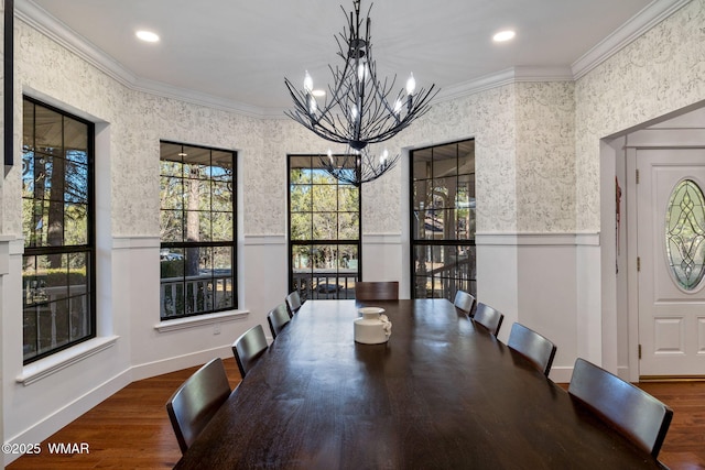 dining area with ornamental molding, wainscoting, and wood finished floors