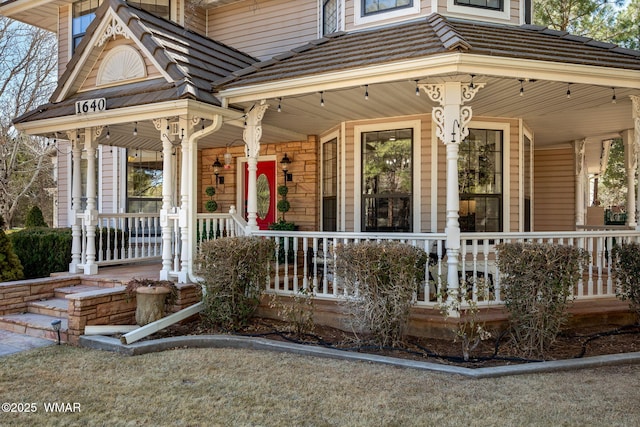 doorway to property with covered porch and a tiled roof