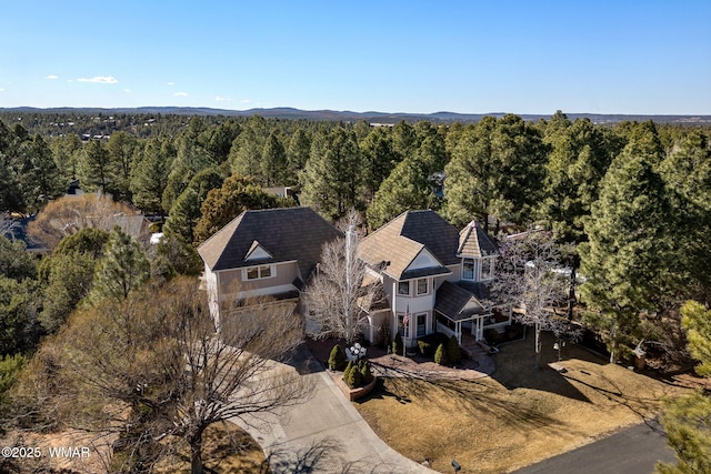 bird's eye view featuring a wooded view