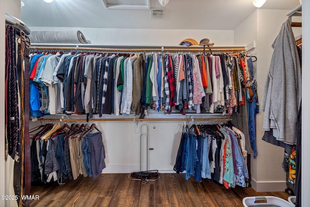 walk in closet with visible vents and wood finished floors