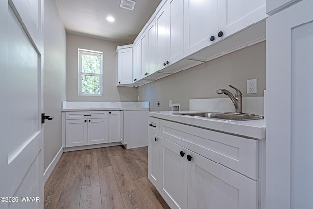 860 E Blue Jay Ln, Show Low, AZ 85901 - laundry area featuring cabinet space, hookup for an electric dryer, washer hookup, light wood-style floors, and recessed lighting