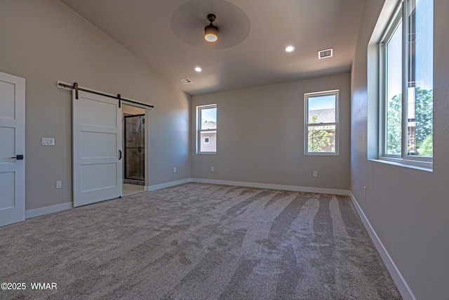 860 E Blue Jay Ln, Show Low, AZ 85901 - unfurnished bedroom with a barn door, carpet, multiple windows, recessed lighting, and lofted ceiling