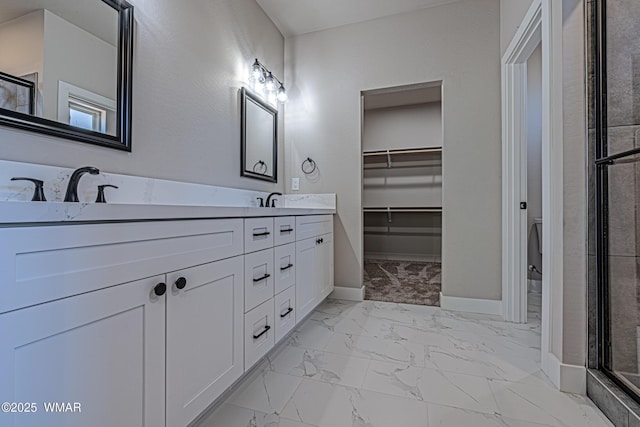 860 E Blue Jay Ln, Show Low, AZ 85901 - bathroom with marble look tiles, double vanity, an enclosed shower, and a spacious closet