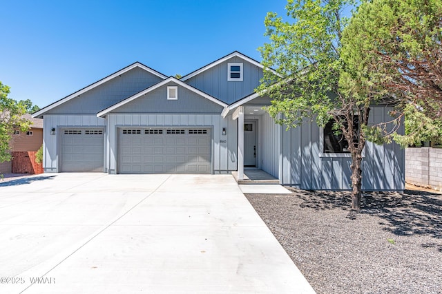 860 E Blue Jay Ln, Show Low, AZ 85901 - view of front of home with a garage, driveway, and board and batten siding