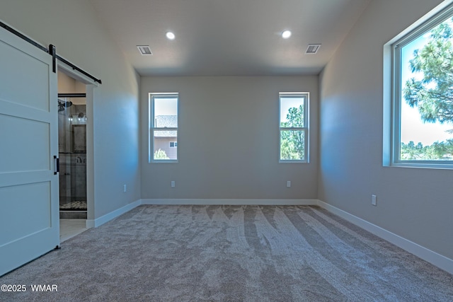 860 E Blue Jay Ln, Show Low, AZ 85901 - unfurnished bedroom with carpet, a barn door, recessed lighting, and ensuite bathroom