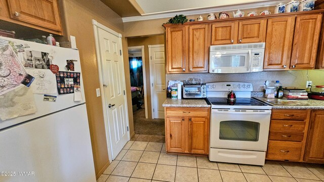 860 N Kiaya Ln, Show Low, AZ 85901 - kitchen featuring white appliances, light tile patterned floors, brown cabinets, and crown molding