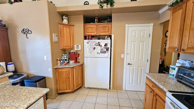 860 N Kiaya Ln, Show Low, AZ 85901 - kitchen featuring white appliances, light tile patterned flooring, light countertops, and brown cabinetry