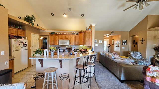 860 N Kiaya Ln, Show Low, AZ 85901 - kitchen featuring white appliances, a ceiling fan, brown cabinets, a peninsula, and high vaulted ceiling