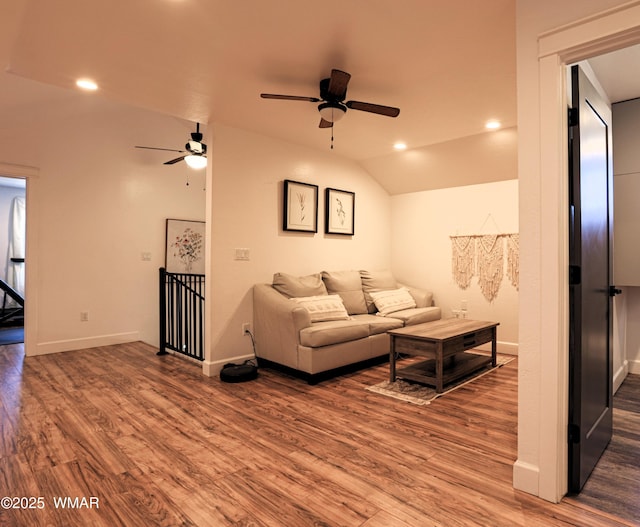 living area featuring baseboards, a ceiling fan, lofted ceiling, wood finished floors, and recessed lighting