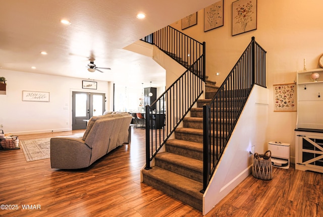 staircase with french doors, recessed lighting, a ceiling fan, wood finished floors, and baseboards