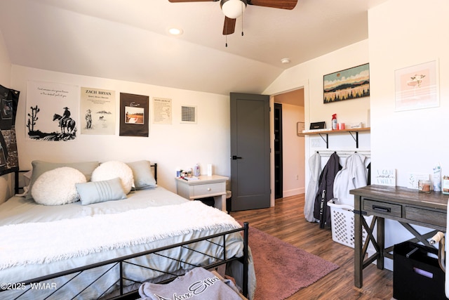 bedroom with ceiling fan, vaulted ceiling, and dark wood finished floors