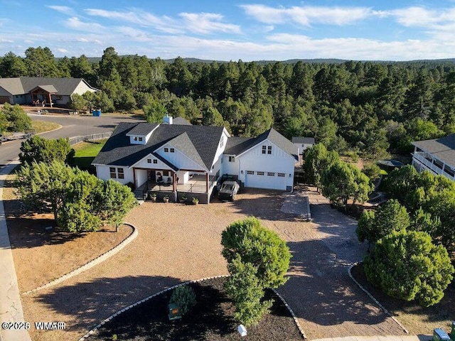 drone / aerial view with a forest view and a residential view