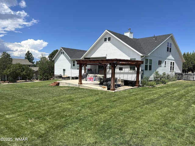 back of house featuring a yard, roof with shingles, a patio area, and a pergola