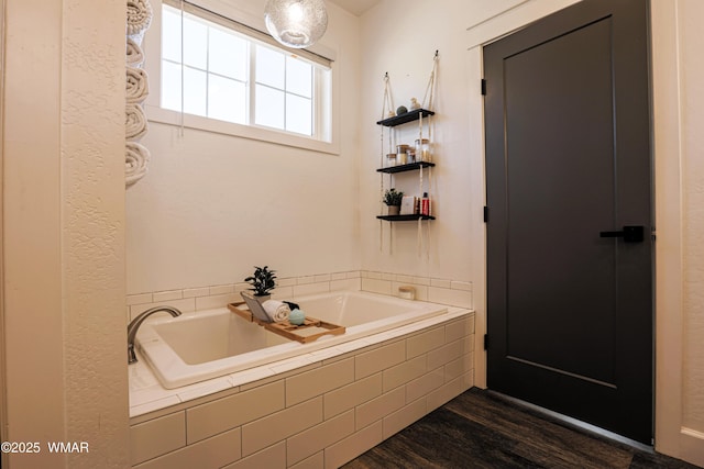 full bath with wood finished floors and a bath