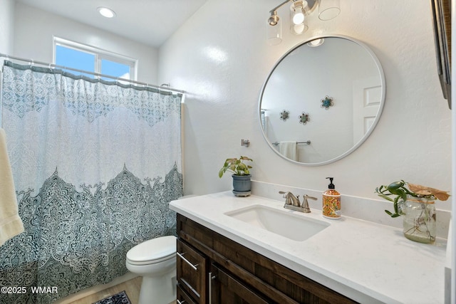 bathroom with toilet, vanity, and a shower with curtain