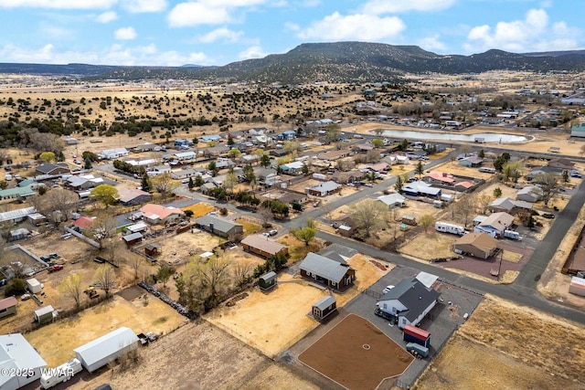 aerial view with a mountain view, a residential view, and view of desert