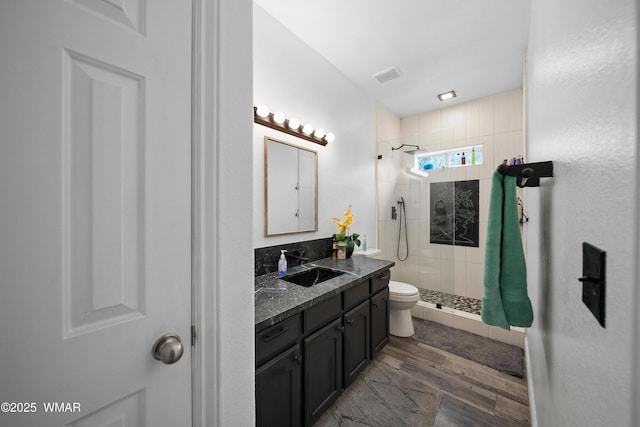 6668 Bandido Way, Show Low, AZ 85901 - bathroom featuring visible vents, a stall shower, wood finished floors, vanity, and toilet
