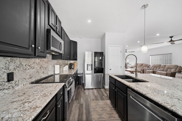 6668 Bandido Way, Show Low, AZ 85901 - kitchen with dark cabinets, a sink, appliances with stainless steel finishes, and dark wood-style floors