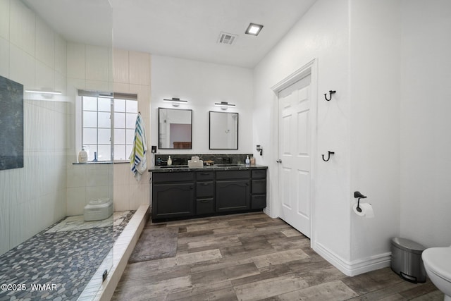 6668 Bandido Way, Show Low, AZ 85901 - full bath featuring a walk in shower, a sink, toilet, wood finished floors, and visible vents