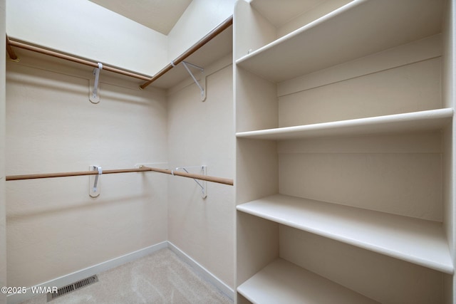 spacious closet with light carpet and visible vents