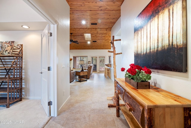 hallway featuring wooden ceiling, baseboards, and recessed lighting