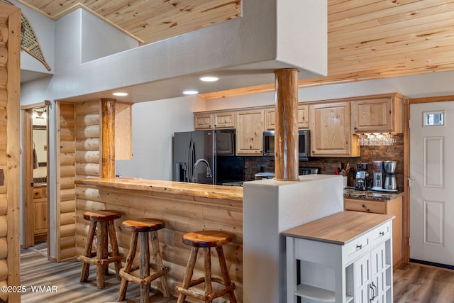 kitchen featuring black refrigerator with ice dispenser, backsplash, light brown cabinetry, wood ceiling, and ornate columns