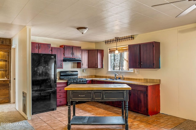 4747 Hidden Way Spur, Show Low, AZ 85901 - kitchen with freestanding refrigerator, range with gas stovetop, a sink, under cabinet range hood, and pendant lighting