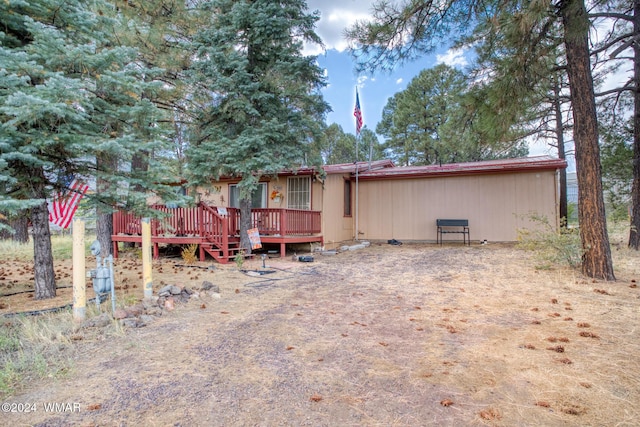 back of property featuring a wooden deck