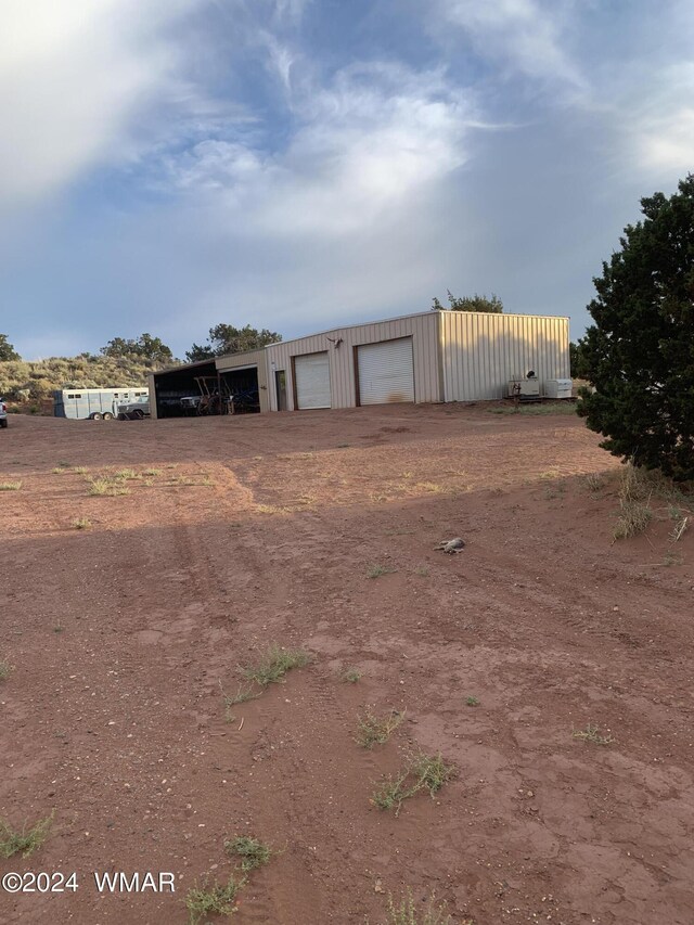 view of yard with a detached garage and an outdoor structure