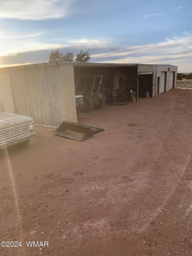 outdoor structure at dusk with an outbuilding