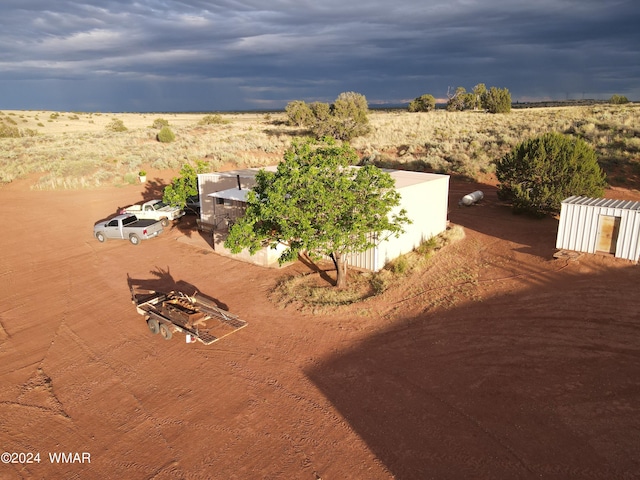 birds eye view of property with a rural view