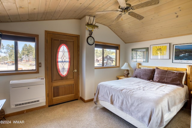 carpeted bedroom featuring vaulted ceiling, heating unit, wood ceiling, and baseboards