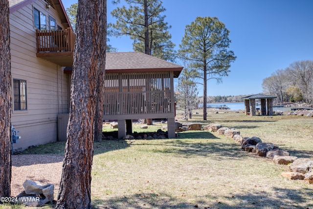 view of yard with a water view, a balcony, and a gazebo