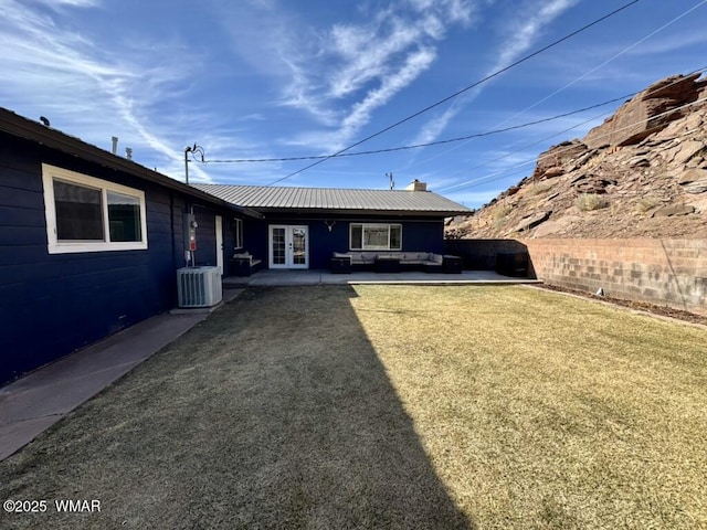 view of yard featuring french doors, fence, an outdoor hangout area, and central AC unit