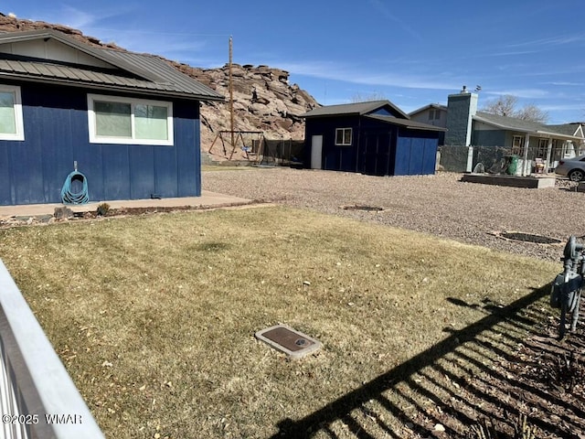 view of yard featuring an outbuilding and fence