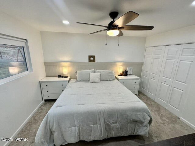 bedroom featuring ceiling fan, carpet floors, a closet, and baseboards